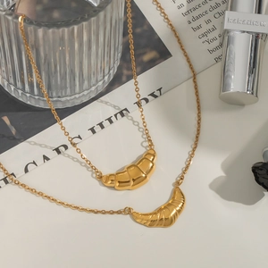 Golden croissant pendant necklaces set with sleek and textured minimalist metal designs