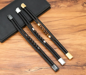 Detail of woven leather bracelets with magnetic clasps and natural volcanic stones