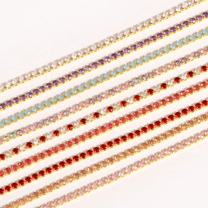 Detail of colorful zircon bracelets in gold claw settings showing vibrant color variety