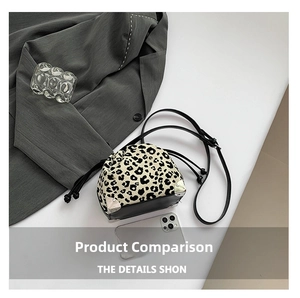 Detail view of leopard print bucket bag with drawstring closure and silver metal corners