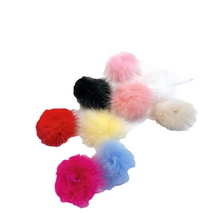 Colorful mink fur pompom balls for DIY jewelry and accessories on white background