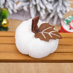 White knitted pumpkin decor with linen stem on rustic wood for Thanksgiving holiday