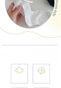 Detail of white cotton socks with 3D bow decoration and embossed bear pattern