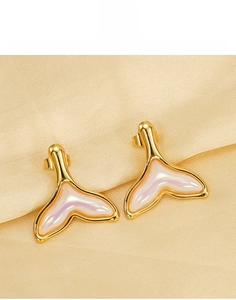 Macro shot of 18K gold plated titanium steel fishtail earrings with pearl shell inlay