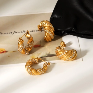 Detailed view of 18K gold plated stainless steel twisted earrings with cubic zirconia