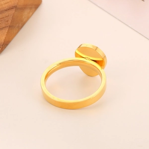 Macro detail of 925 hallmark on the inner band of a golden oval minimalist ring