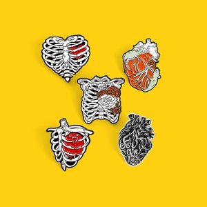 Detailed set of five medical enamel pins featuring anatomical heart and ribcage designs