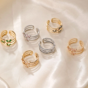 Set of six adjustable butterfly rings with colorful cubic zirconia on silk fabric