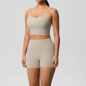 Detail of high-waist yoga shorts and strappy sports bra in premium greige fabric