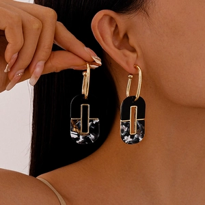 Modern dark style acrylic oval geometric earrings featuring gold-plated metal accents