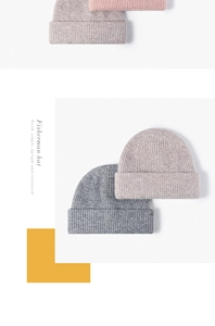 Detail of ribbed knit texture on pink, beige and grey winter beanies with folded cuffs