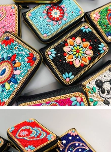 Detail of bohemian handmade beaded coin purses featuring colorful geometric embroidery
