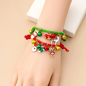 Detailed view of handwoven Christmas bracelet with Santa, reindeer and bell charms