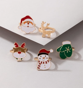 Detail view of a 5-piece Christmas ring set with Santa, reindeer and snowman oil drip designs