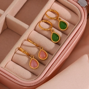 Detail of teardrop cat eye stone earrings in pink and green with gold plating