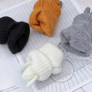 Knit winter beanies in black orange grey and cream colors with soft mohair texture
