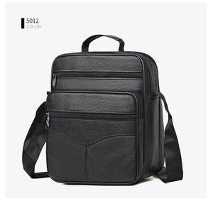 Close-up of black leather crossbody bag with multiple zippers and litchi texture finish