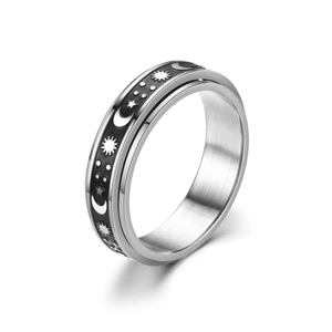 Detail view of rotating stainless steel ring with black celestial sun moon star pattern