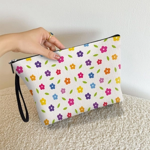 Floral canvas makeup bag with colorful flower patterns, black zipper, and wrist strap