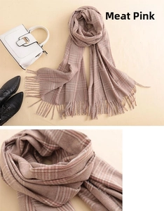 Close-up detail of pinkish beige plaid cashmere scarf with soft fringes and fine texture