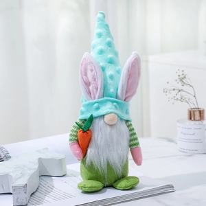 Easter gnome plush doll with rabbit ears and orange carrot on a clean white background