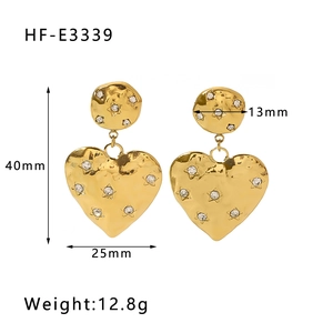 Detailed view of gold heart drop earrings with dimensions 40mm height and 25mm width