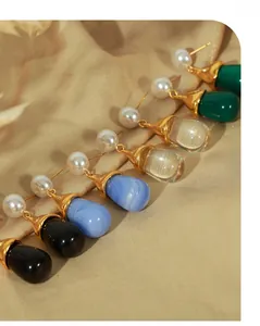 Detailed view of colorful resin waterdrop earrings with faux pearls and gold plating