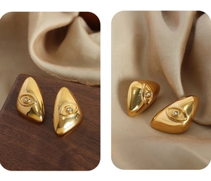 Detailed view of gold plated geometric eye earrings with clear center zircon stones