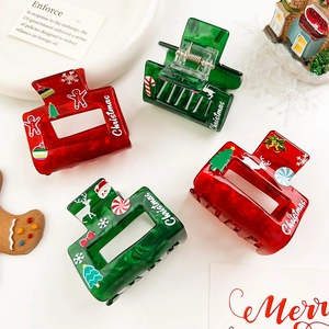 Christmas hair claws with festive patterns including gingerbread man and reindeer icons