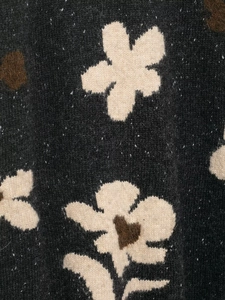 Close-up of the vintage floral jacquard pattern and knitted texture on the cardigan