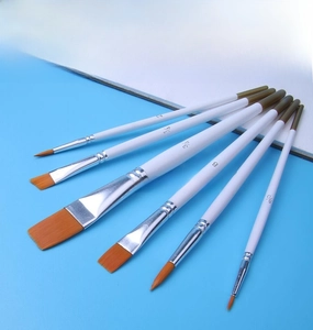 Detail of 6-piece paint brush set with orange synthetic bristles on blue background