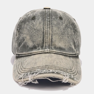 Detail of distressed brim and washed cotton fabric on retro vintage baseball cap