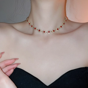 Detail shot of the sparkling flower pendant necklace worn around the model's collarbone