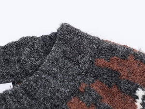 Macro view of soft mohair knit texture in dark grey and caramel brown patchwork