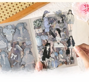 Close-up of peeling PET stickers featuring forest style girl illustrations from a book