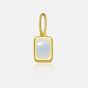 Macro shot of gold rectangle pendant with a light blue zircon gemstone on a grey background