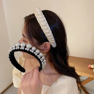 Detail of velvet headbands with mixed size pearls in black and cream white colors