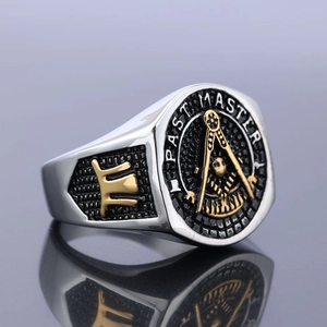 Macro detail of silver Past Master Masonic ring with golden compass and square emblem
