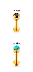 Macro detail of gold-plated titanium labret studs with turquoise and black gemstones