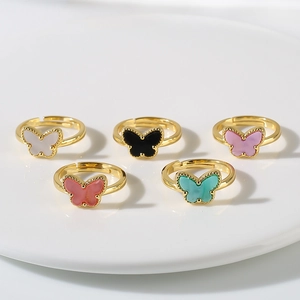 Detailed view of five colorful butterfly open rings in gold plating with enamel finish