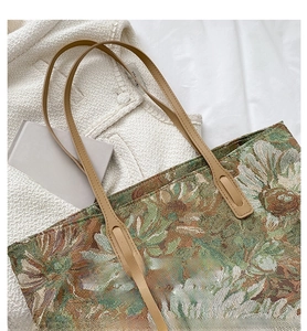 Detail of vintage floral jacquard tote bag featuring premium brown leather shoulder straps