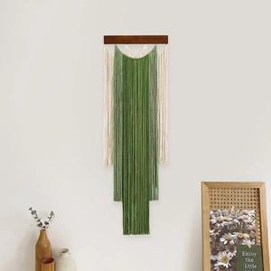 Handmade gradient tassel tapestry with forest green and white cotton ropes on wooden beam