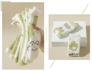 Close-up of green cartoon frog coral fleece socks featuring Lucky and Hello embroidery