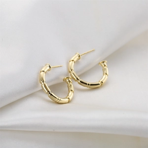 Minimalist 14K gold plated bamboo joint design earrings on white silk background