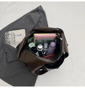 Top view of spacious interior of dark brown tote bag showing large storage capacity