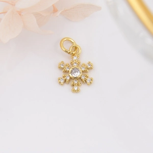 Macro shot of 18k gold plated snowflake pendant with sparkling zircons and fine details