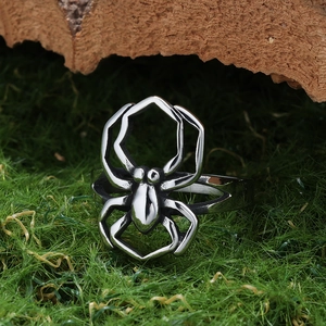 Gothic style spider shaped ring in vintage silver finish on natural moss background