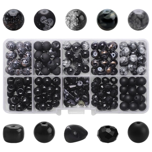 Detail of 10-compartment box with matte and cracked glass beads for DIY jewelry making