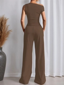 Rear view of brown two-piece set featuring one-shoulder top and high waist wide leg pants