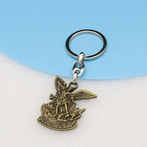 Close-up of Saint Michael bronze keychain pendant with detailed angel and dragon carving